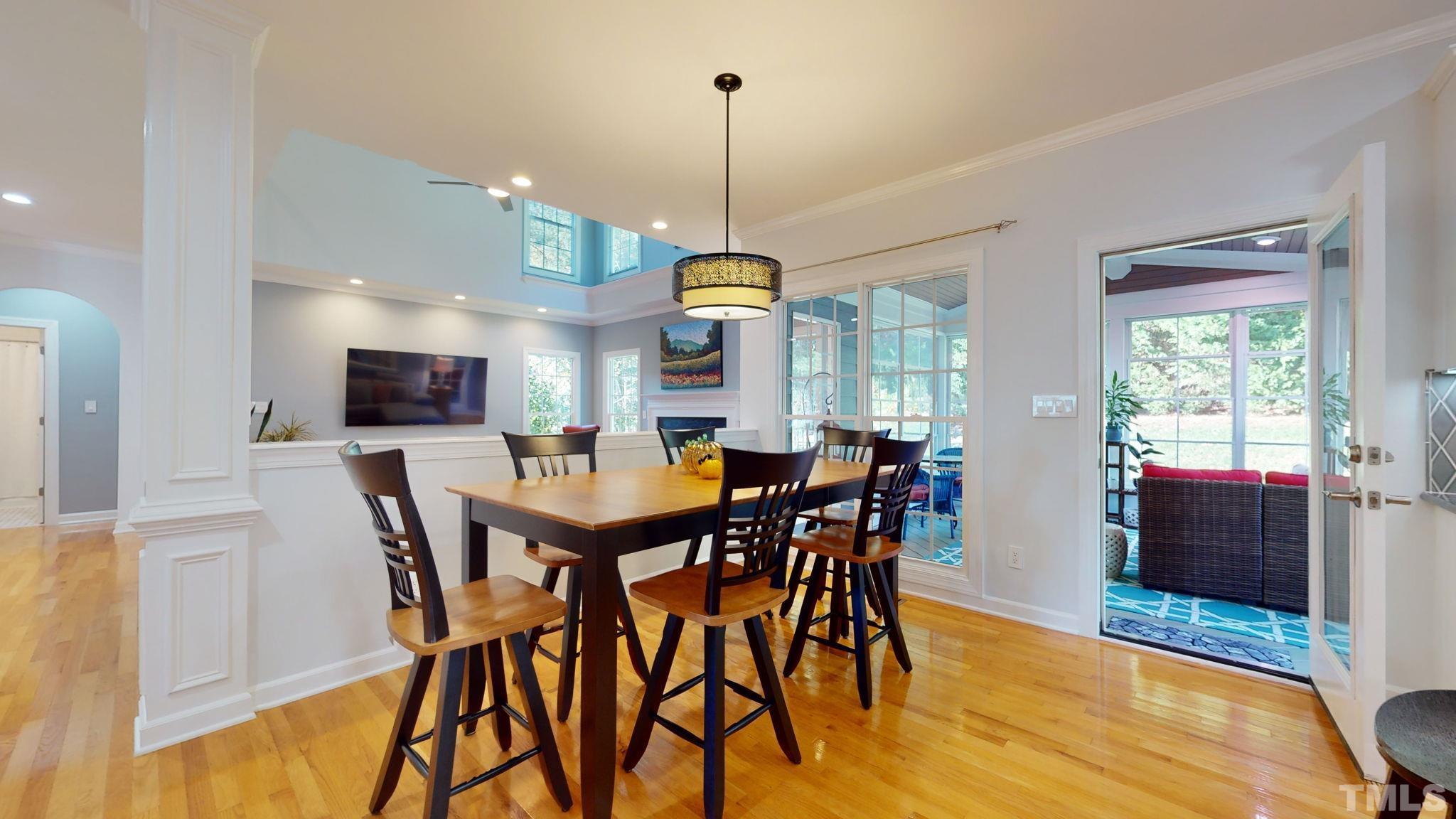1512 Wood Spring Court Raleigh, NC 27614 - Photo 15 of 39 a view of a dining room with furniture window and wooden floor