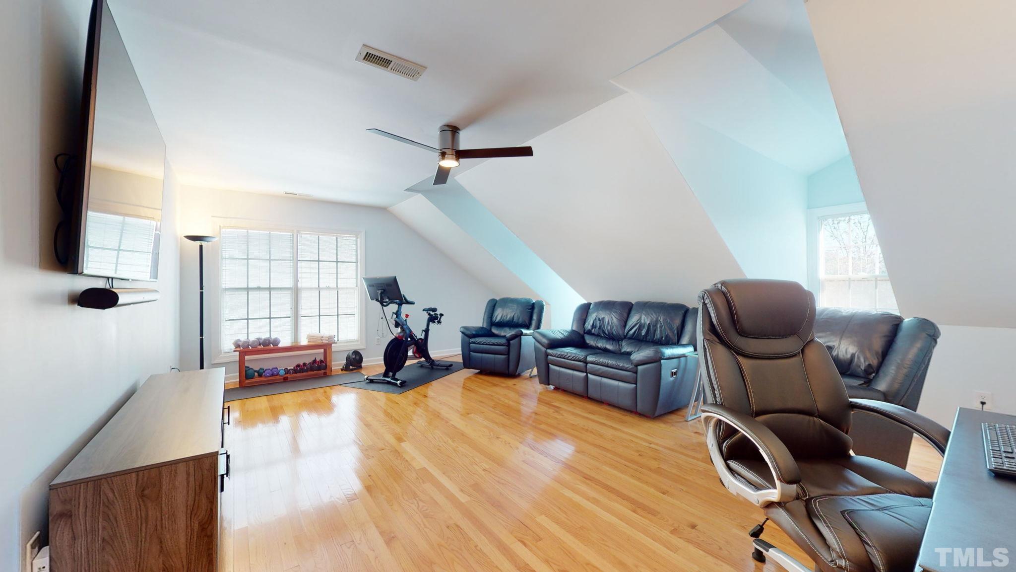 1512 Wood Spring Court Raleigh, NC 27614 - Photo 26 of 39 a living room with furniture a flat screen tv and a large window