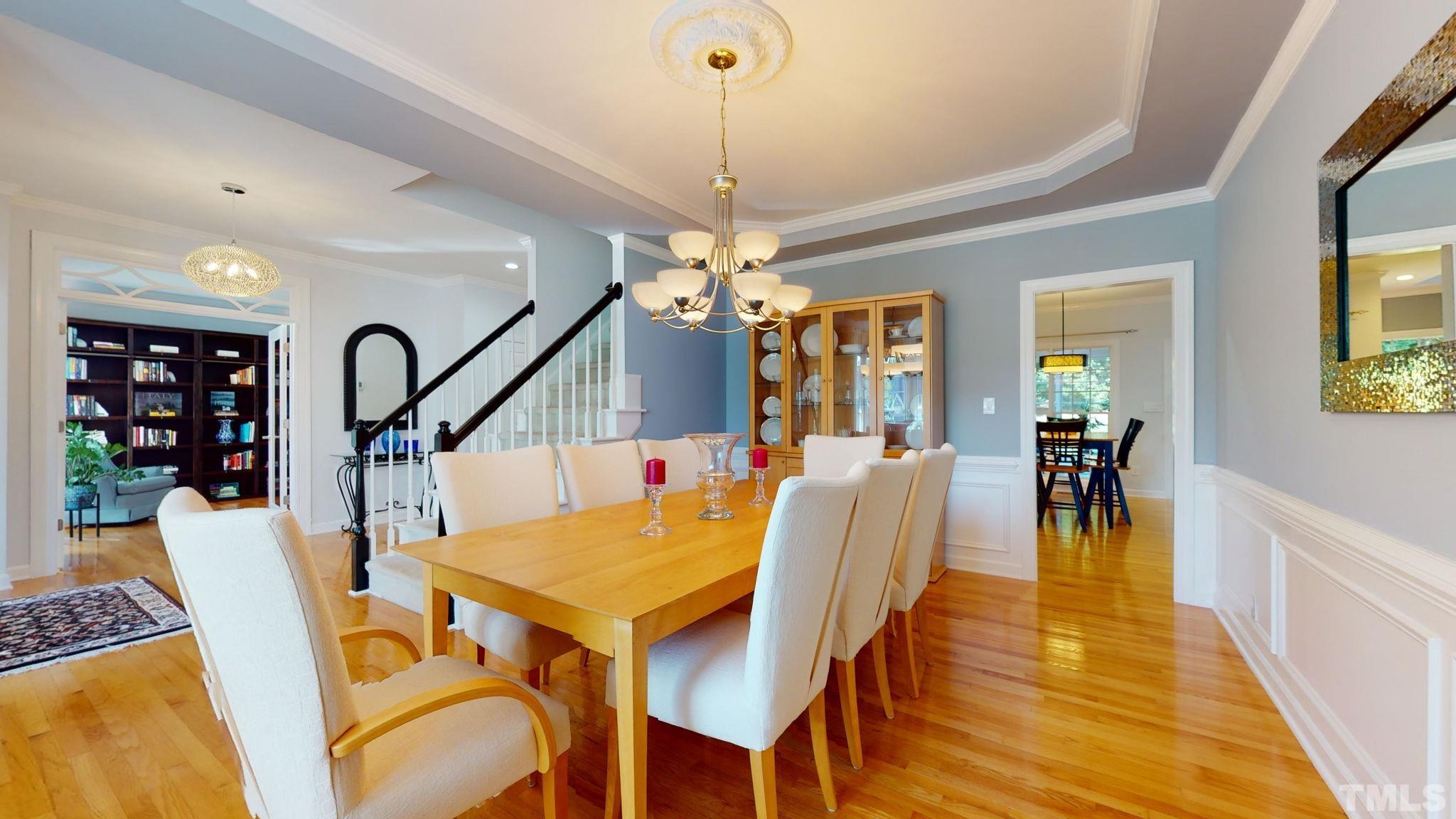 1512 Wood Spring Court Raleigh, NC 27614 - Photo 8 of 39 a dining room with furniture a chandelier and wooden floor