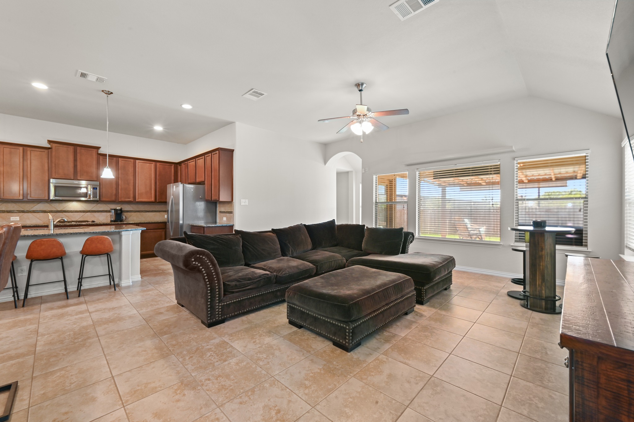 877 Hot Spring Valley Buda, TX 78610 - Photo 10 of 36 a living room with furniture and a kitchen view