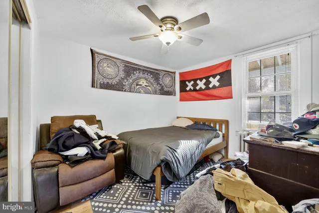 a bedroom with furniture and a window