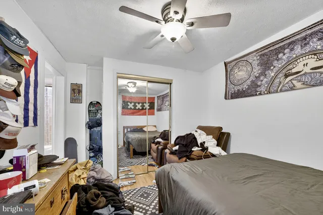 a bed room with a bed and a computer on a desk