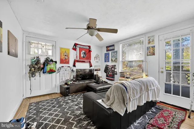 a bedroom with furniture and a flat screen tv
