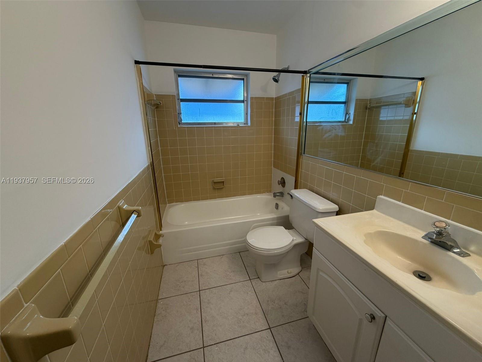 9507 Northwest 80th Court Tamarac, FL 33321 - Photo 11 of 22 a bathroom with a sink a toilet and shower