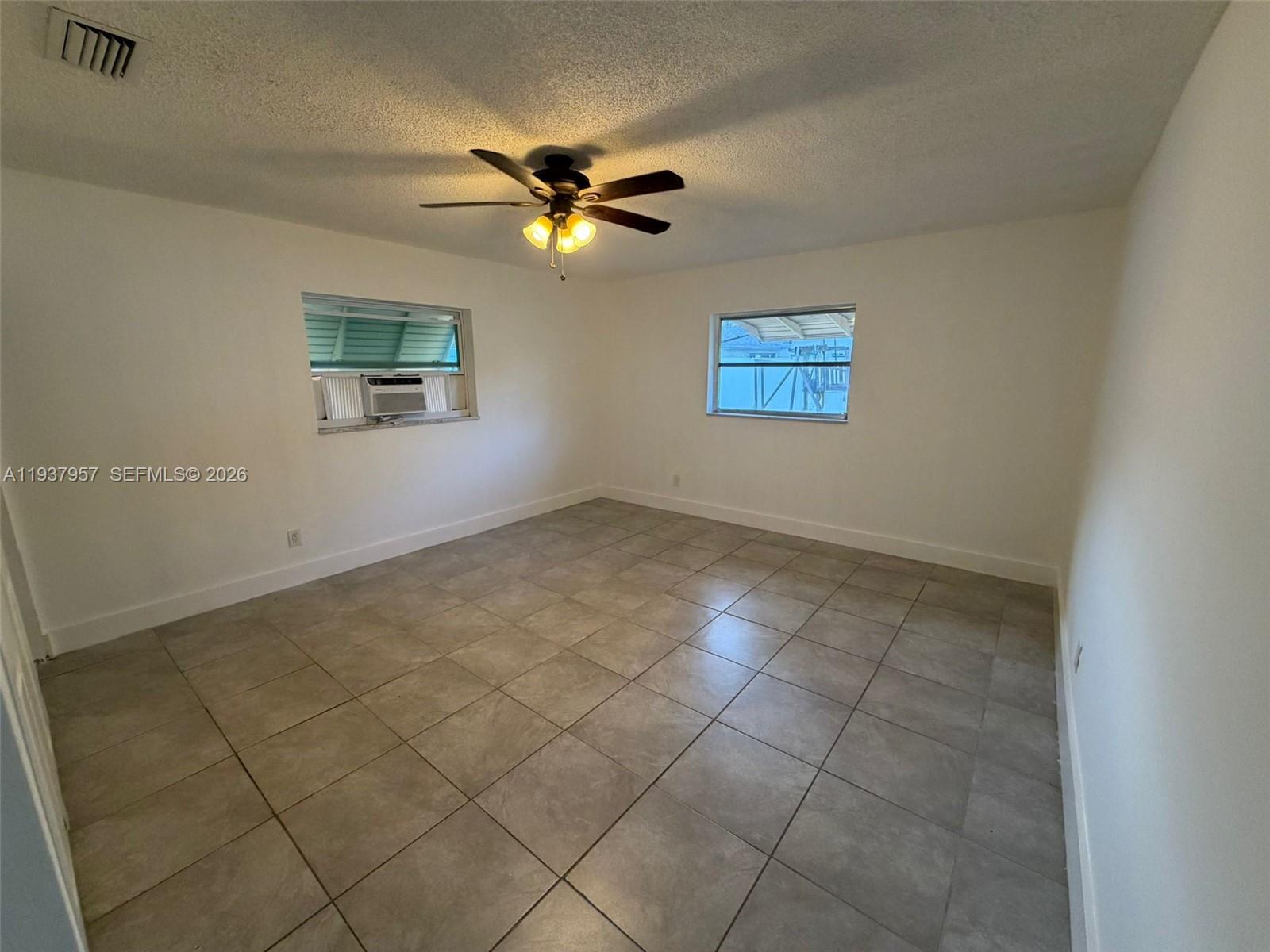9507 Northwest 80th Court Tamarac, FL 33321 - Photo 14 of 22 a view of a livingroom with a fan