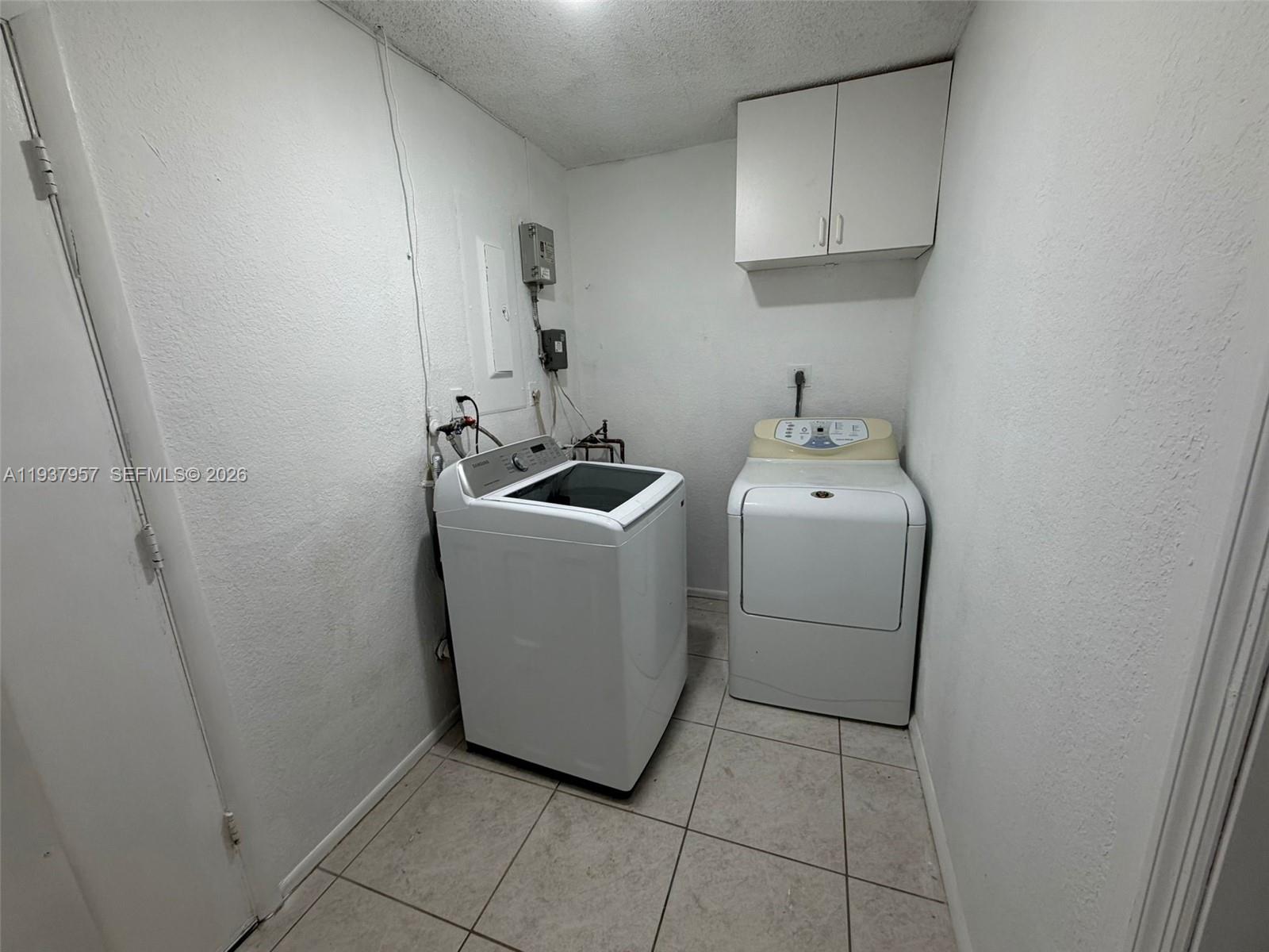 9507 Northwest 80th Court Tamarac, FL 33321 - Photo 17 of 22 a utility room with dryer and washer