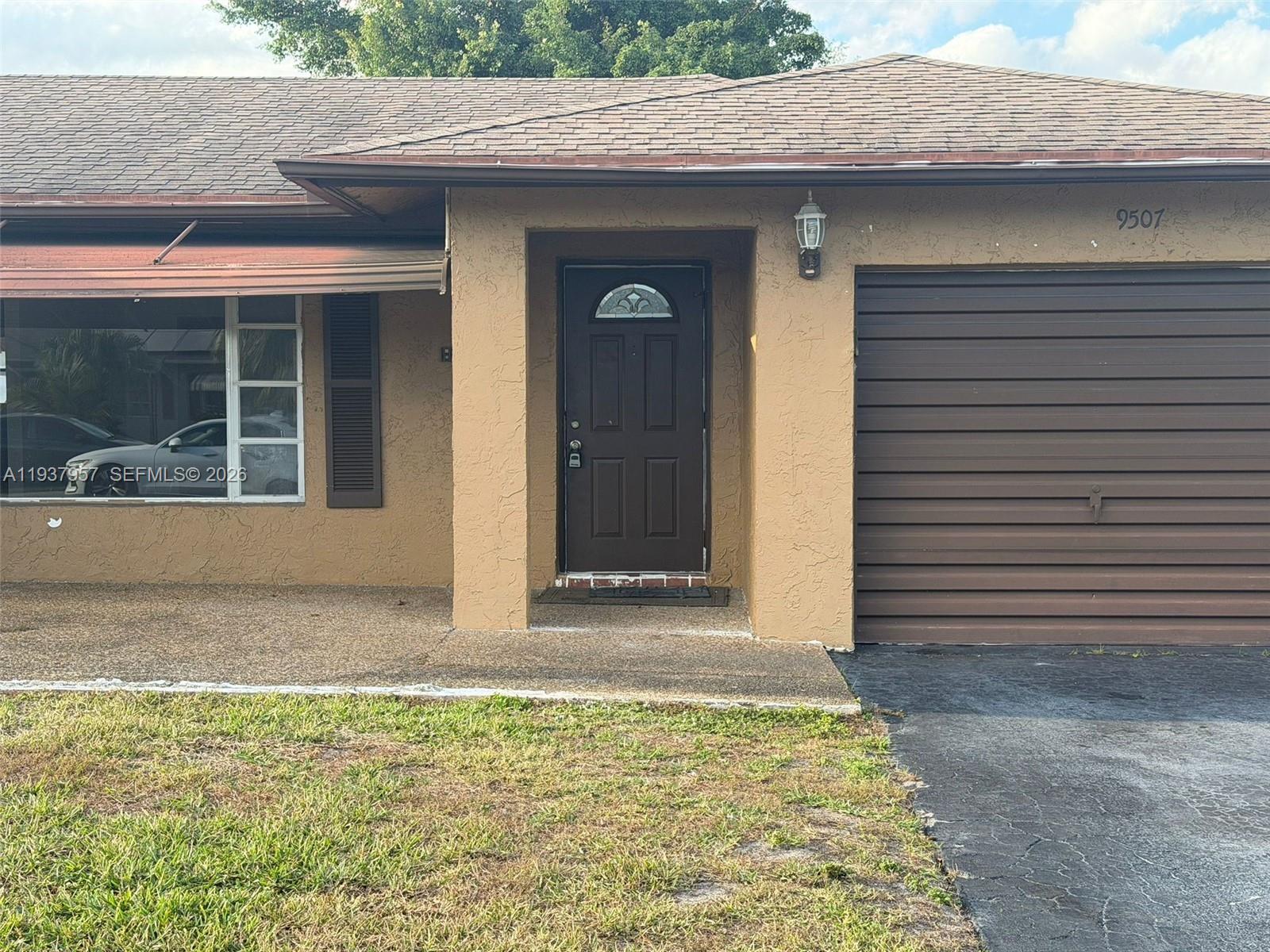 9507 Northwest 80th Court Tamarac, FL 33321 - Photo 19 of 22 a front view of a house