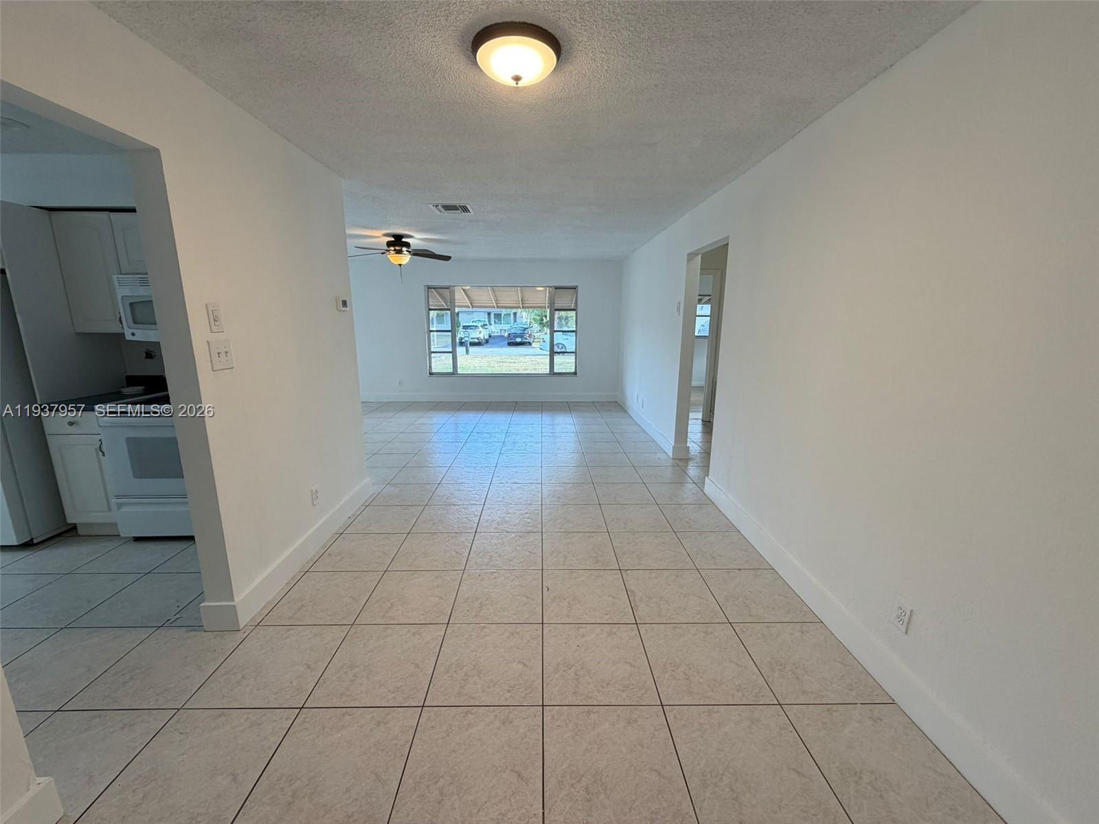 9507 Northwest 80th Court Tamarac, FL 33321 - Photo 2 of 22 a view of a livingroom with an empty space and a window