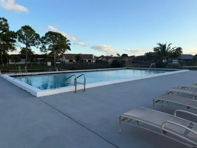 a room with pool table and windows