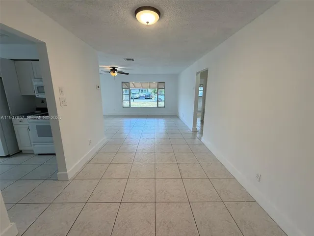 a view of a livingroom with an empty space and a window