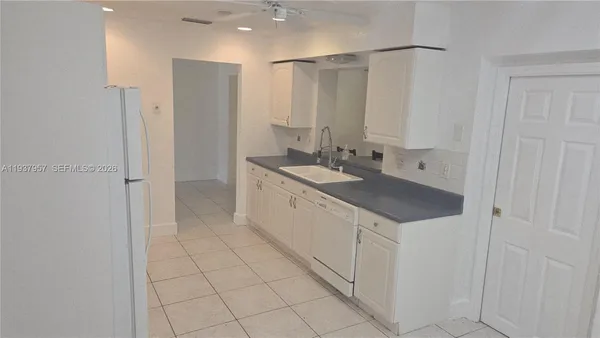 a bathroom with a granite countertop sink a mirror and a shower