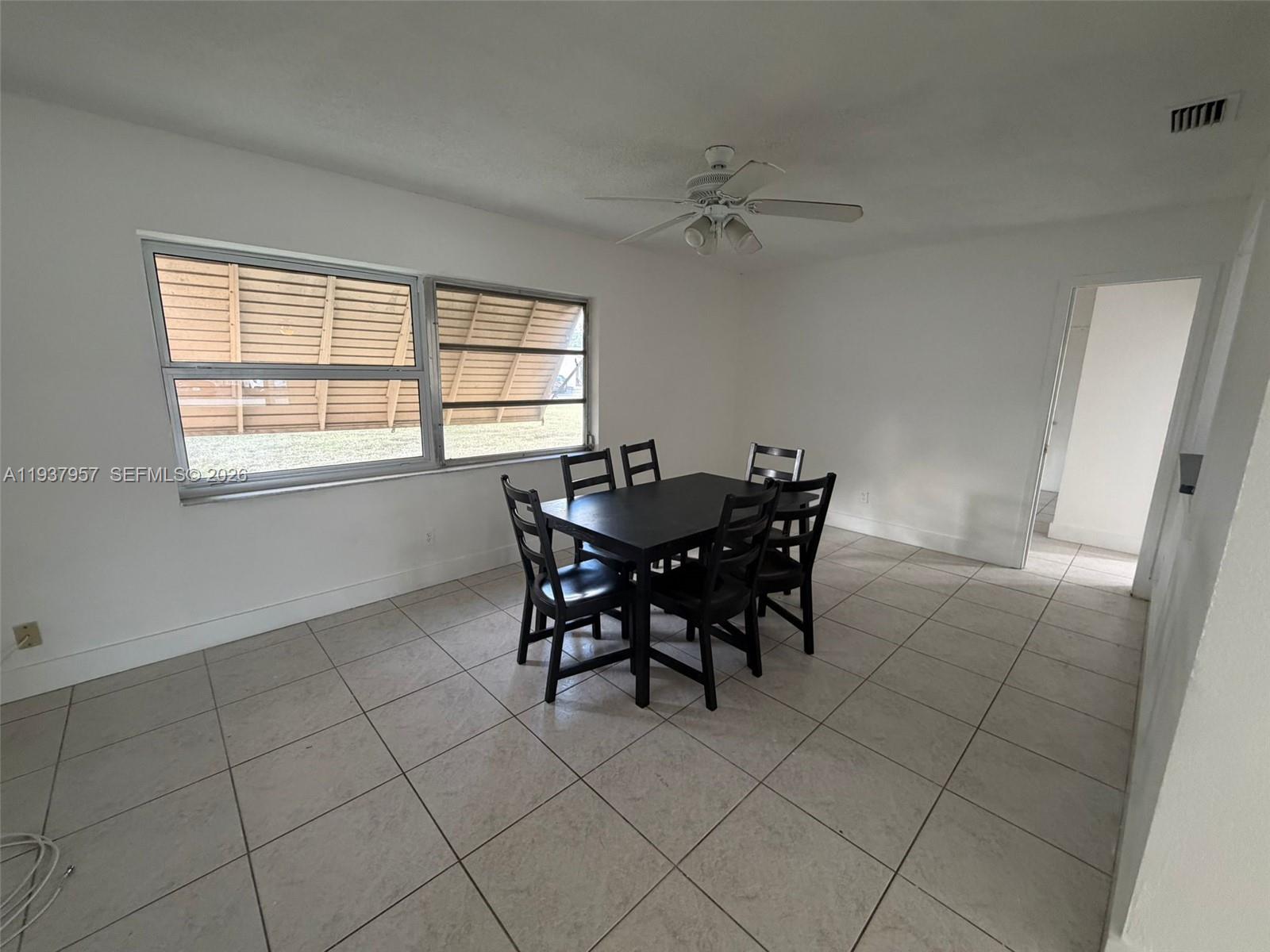 9507 Northwest 80th Court Tamarac, FL 33321 - Photo 7 of 22 a dining room with furniture and window