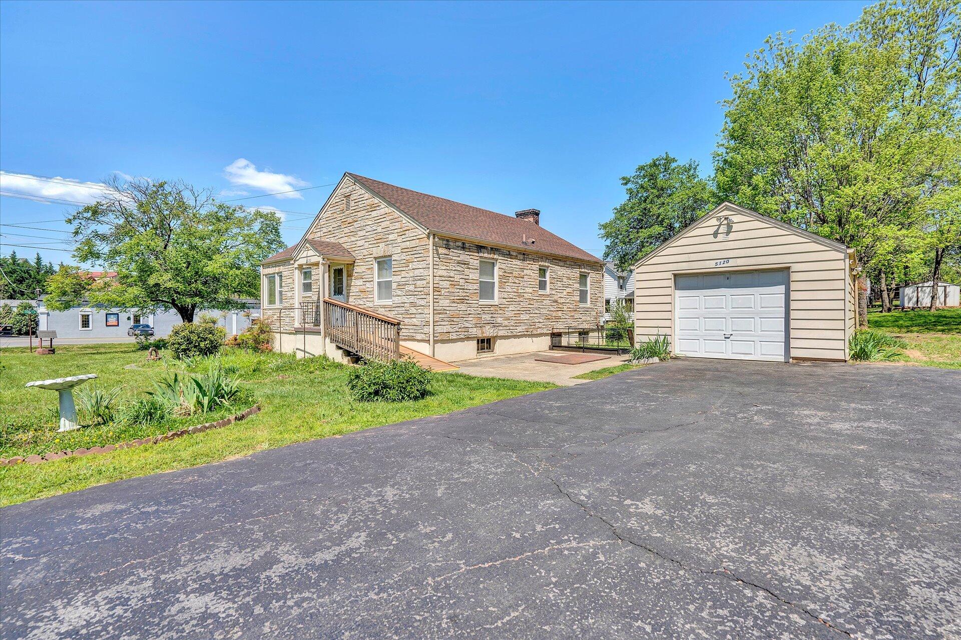 5120 Starkey Road Roanoke, VA 24018 - Photo 16 of 17 a front view of a house with a yard and garage
