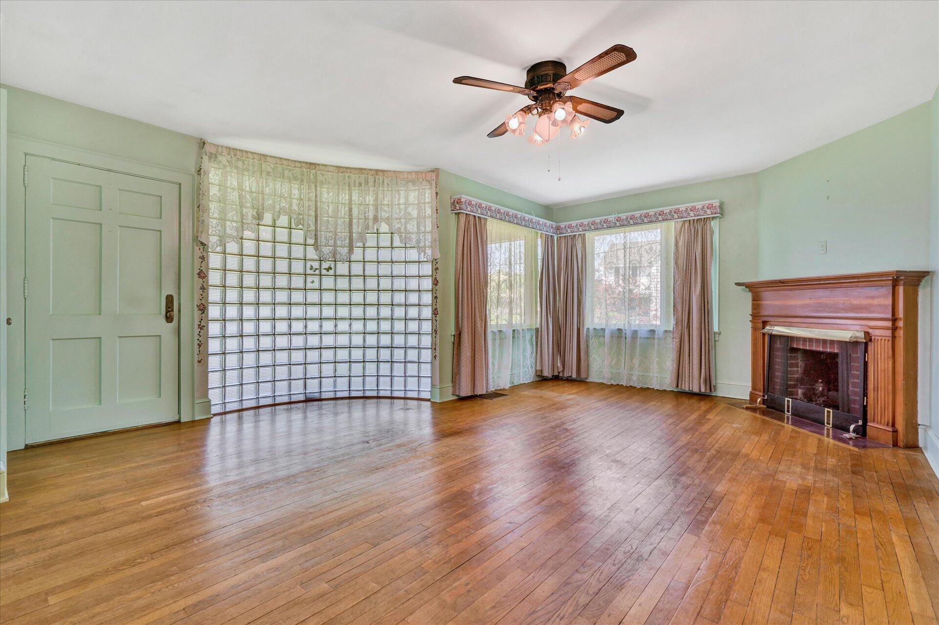 5120 Starkey Road Roanoke, VA 24018 - Photo 4 of 17 a view of an empty room with a window and wooden floor