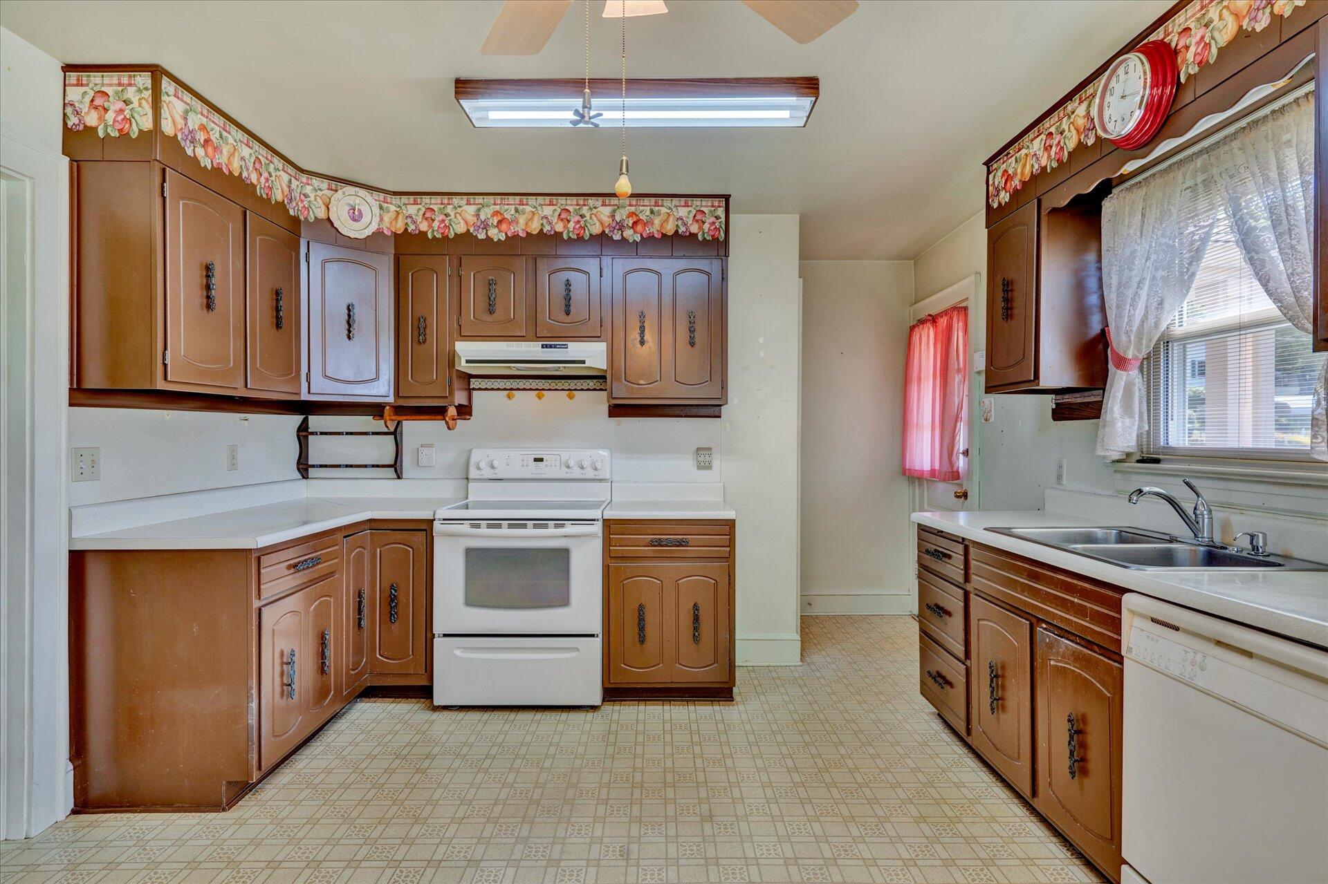5120 Starkey Road Roanoke, VA 24018 - Photo 6 of 17 a kitchen with stainless steel appliances granite countertop a sink stove and cabinets