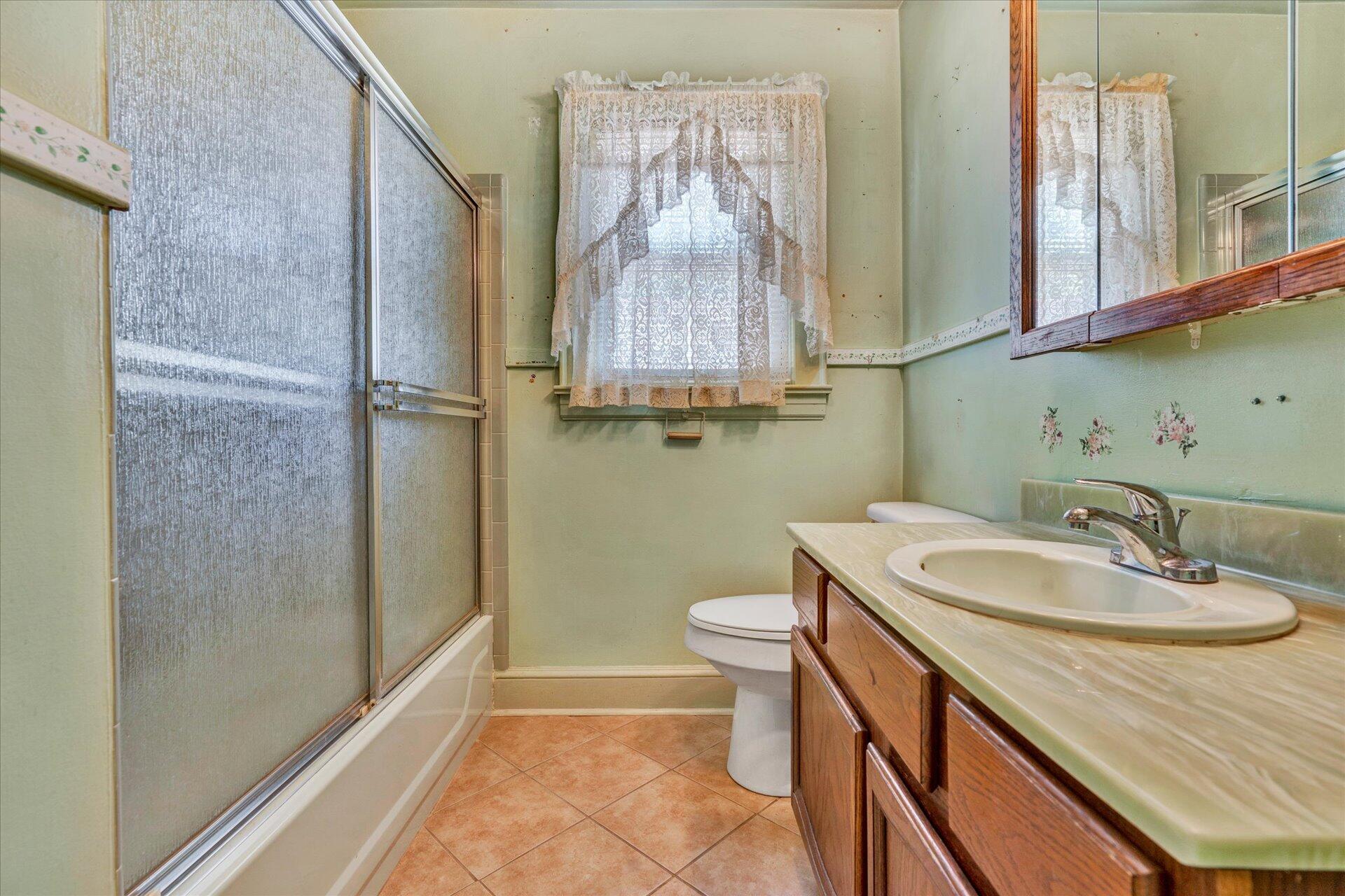 5120 Starkey Road Roanoke, VA 24018 - Photo 9 of 17 a bathroom with a sink a toilet and a mirror