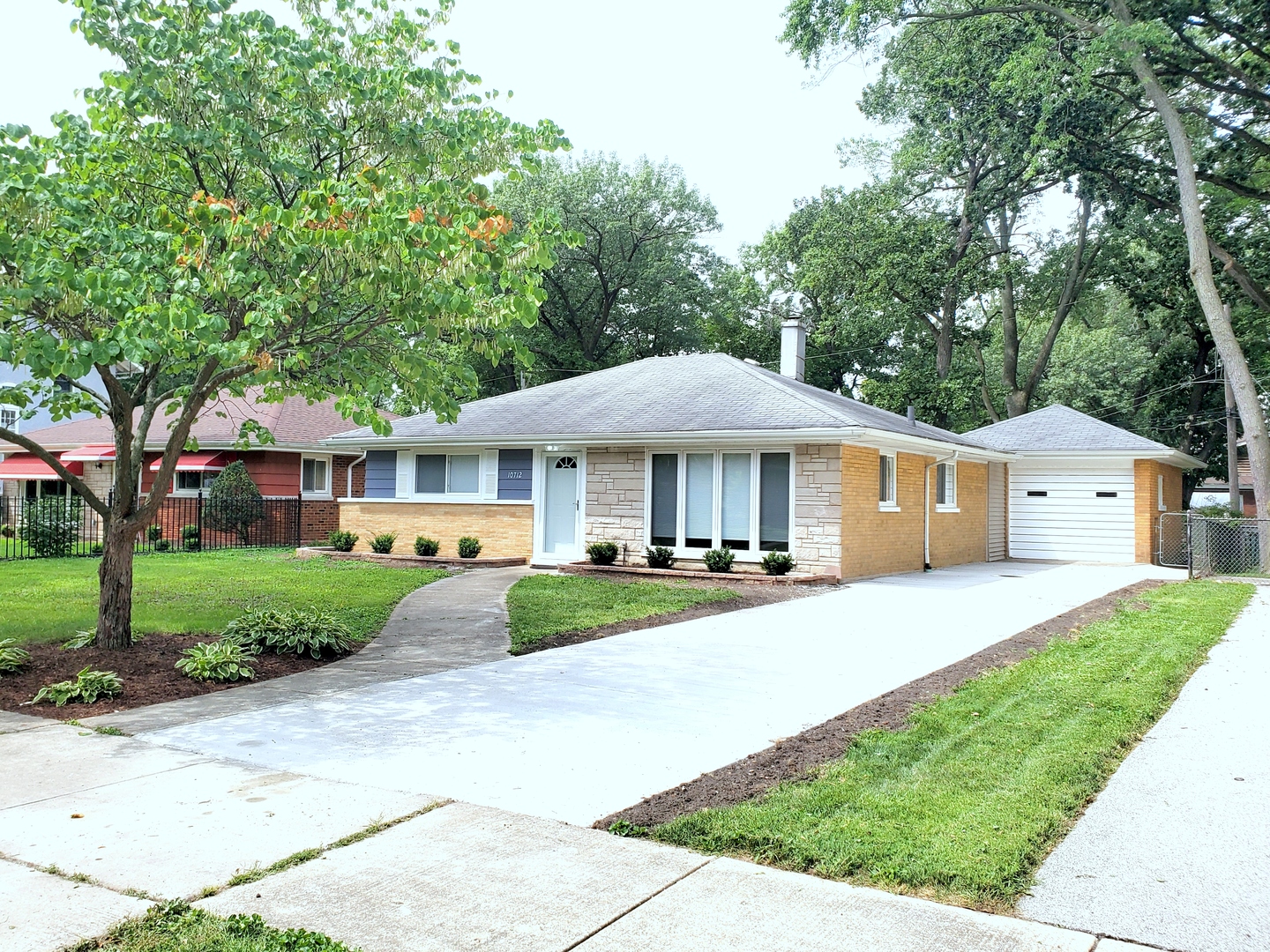 10712 South Drew Street Chicago, IL 60643 - Photo 1 of 1 a front view of a house with a yard table and chairs