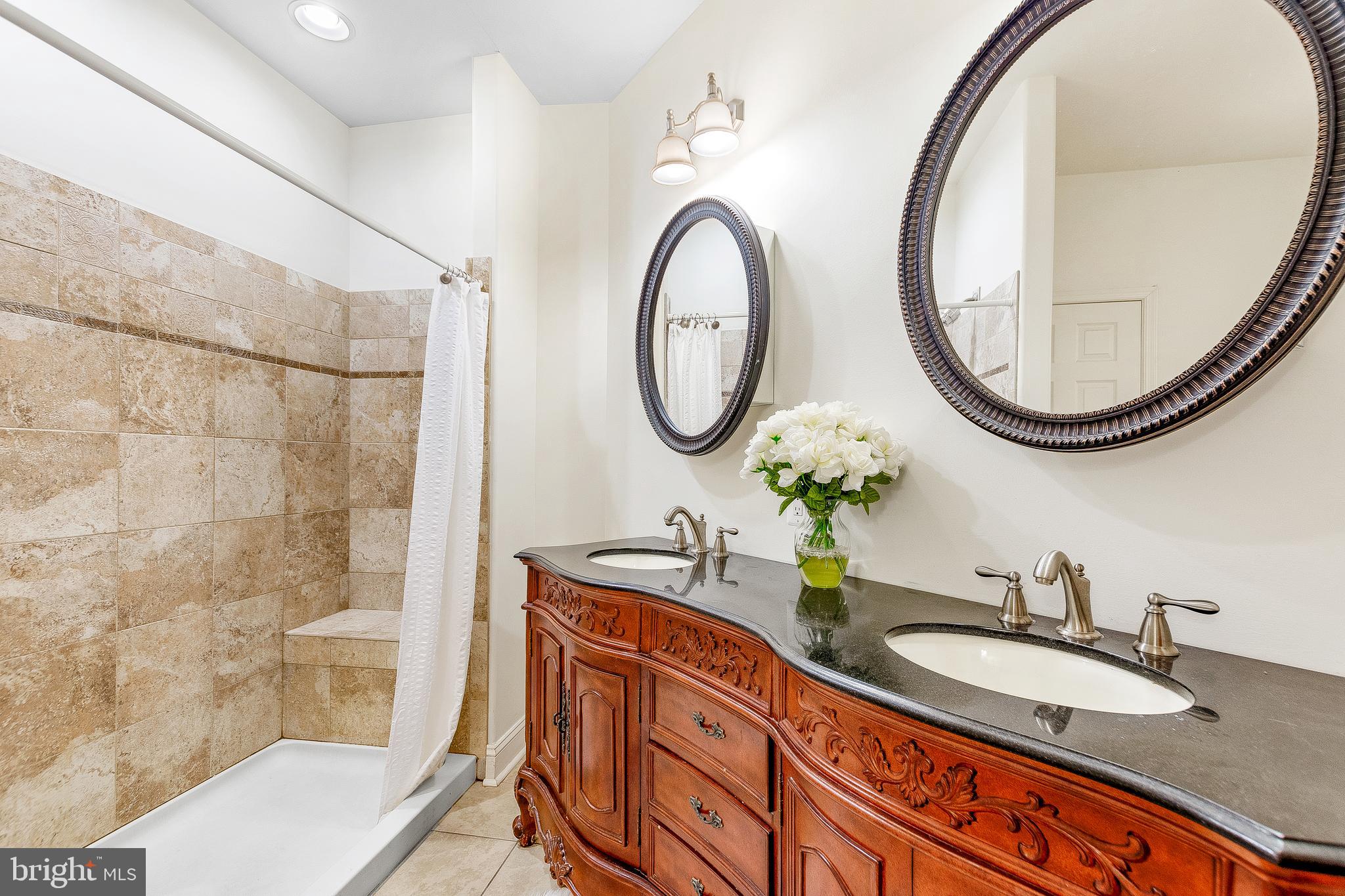 1808 Wilson Road Huntingtown, MD 20639 - Photo 27 of 53 a bathroom with a double vanity sink and a mirror