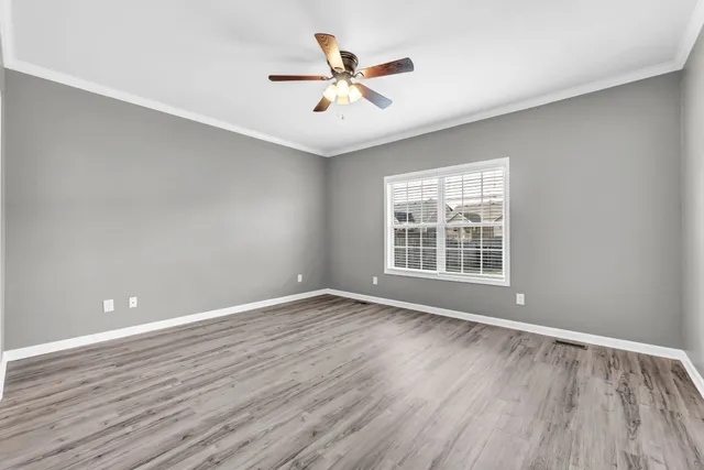 wooden floor in an empty room with a window