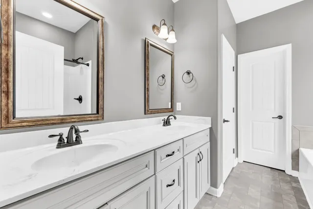 a bathroom with a double vanity sink mirror and