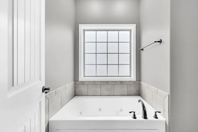 a white bath tub sitting next to a window