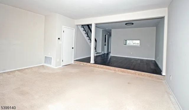 a view of a big room with closet and windows