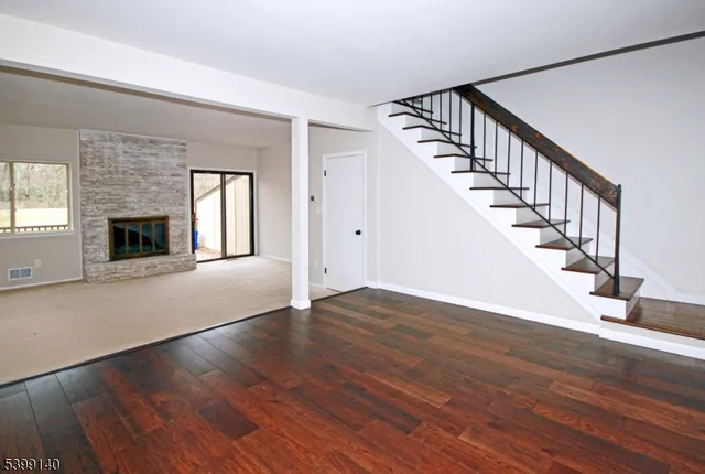 a view of a room with wooden floor and staircase
