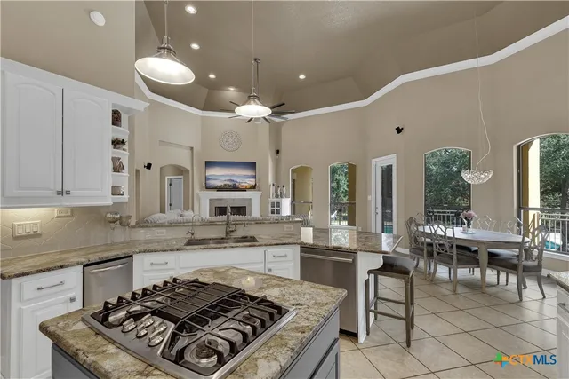 a kitchen with stove and cabinets