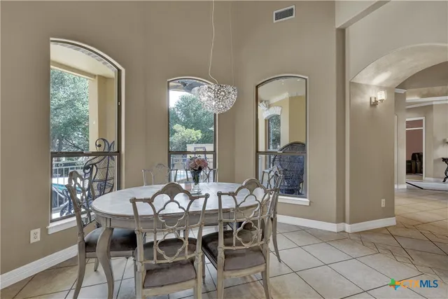 a view of a dining room with furniture and chandelier