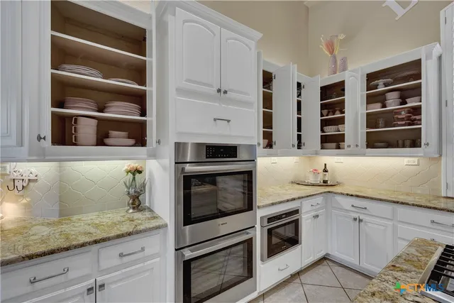 a kitchen with stainless steel appliances granite countertop a stove and a microwave
