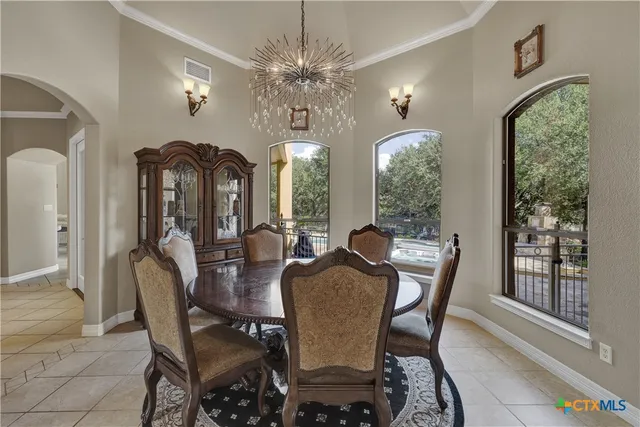 a view of a dining room with furniture and chandelier