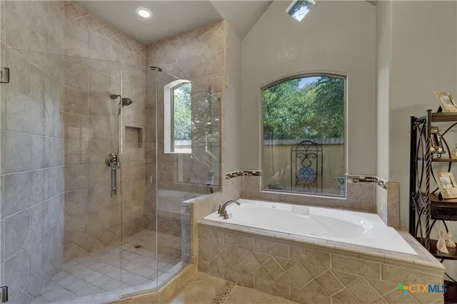 a spacious bathroom with a tub shower and sink