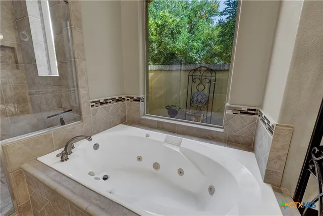 a bathroom with a tub and shower