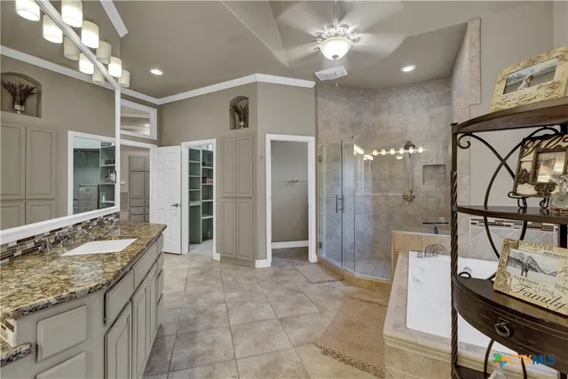 a bathroom with a granite countertop sink a mirror and a shower