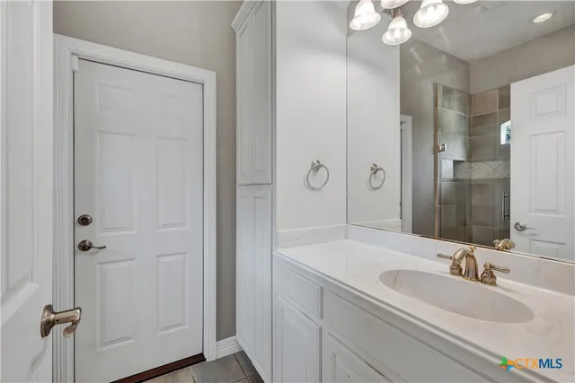 a bathroom with a sink double vanity granite tub and shower