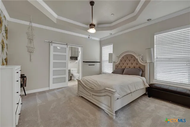 a spacious bedroom with a bed and a walk in closet