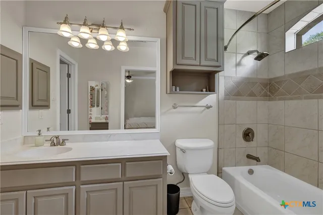 a bathroom with a sink a toilet and bathtub