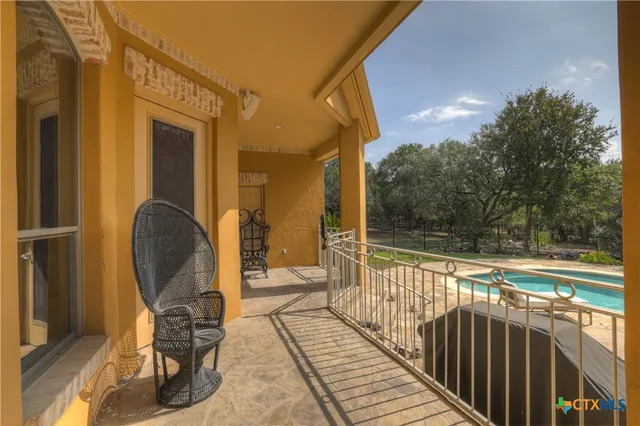 a view of a balcony with chair and glass door