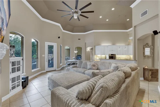 a living room with furniture ceiling fan and a rug