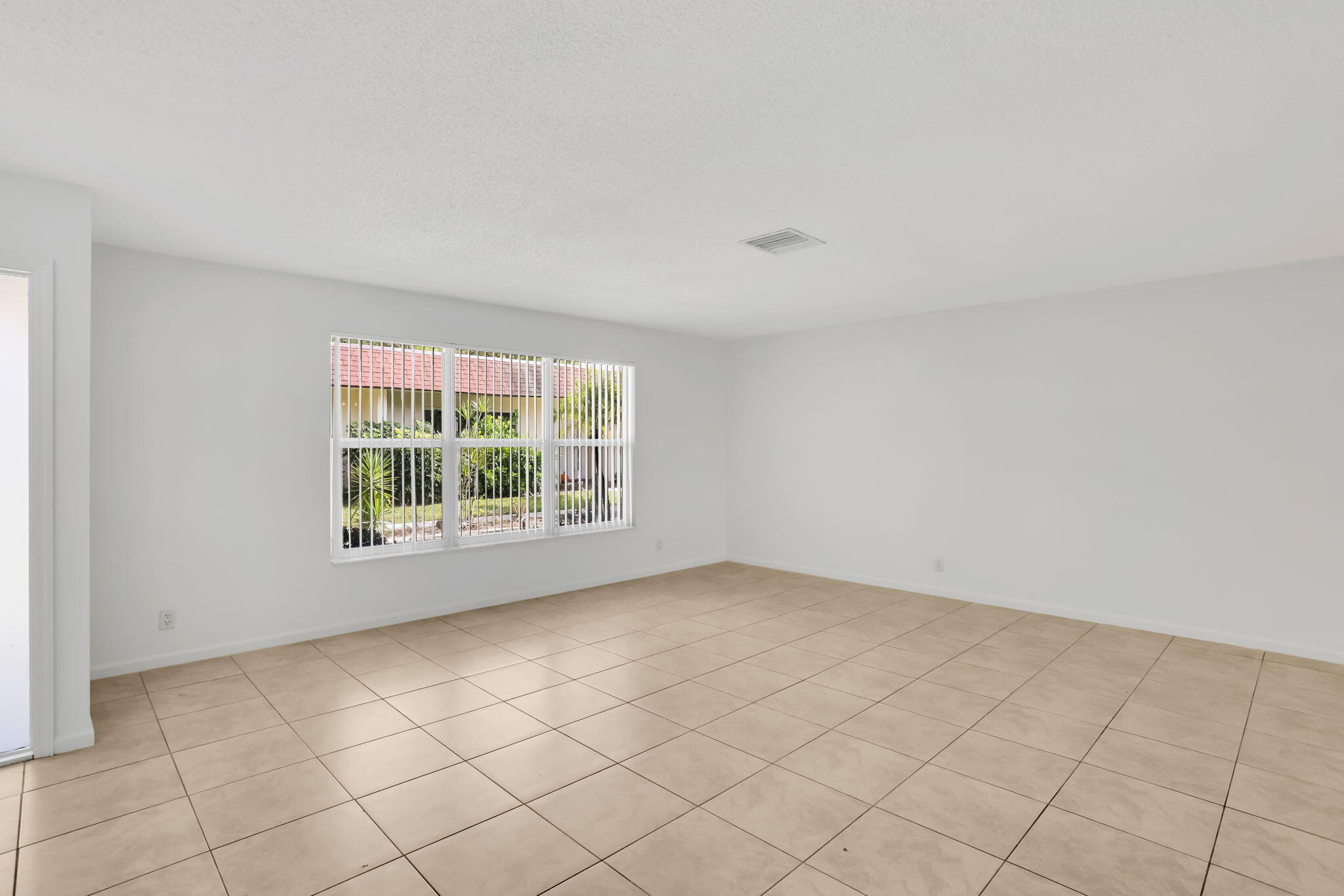 89 Lariat Circle Boca Raton, FL 33487 - Photo 4 of 31 an empty room with windows