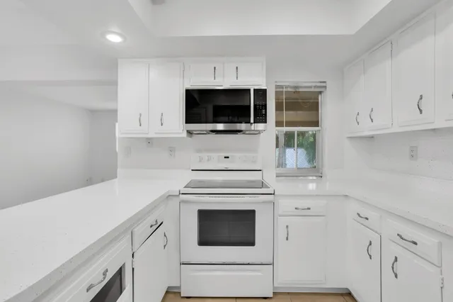 a kitchen with a refrigerator and cabinets