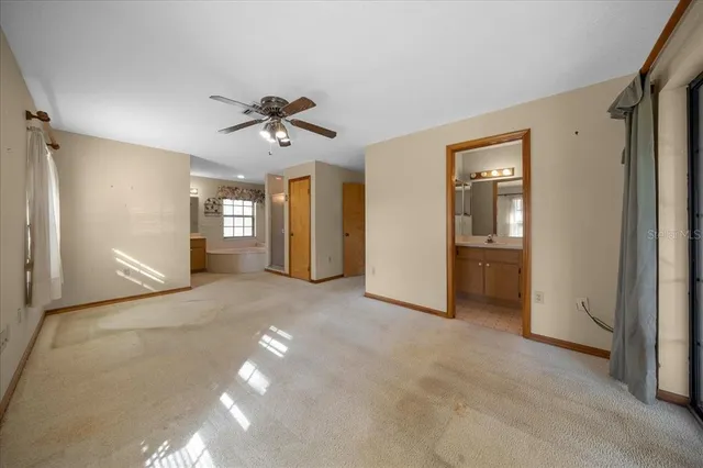 a view of a house with a big yard and large trees