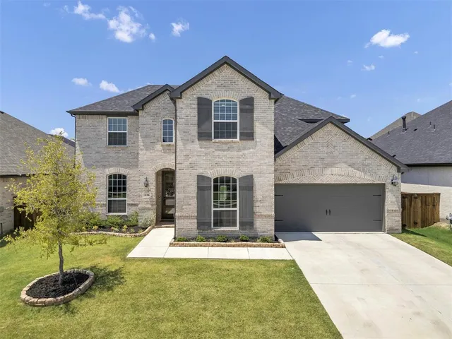 a front view of a house with yard