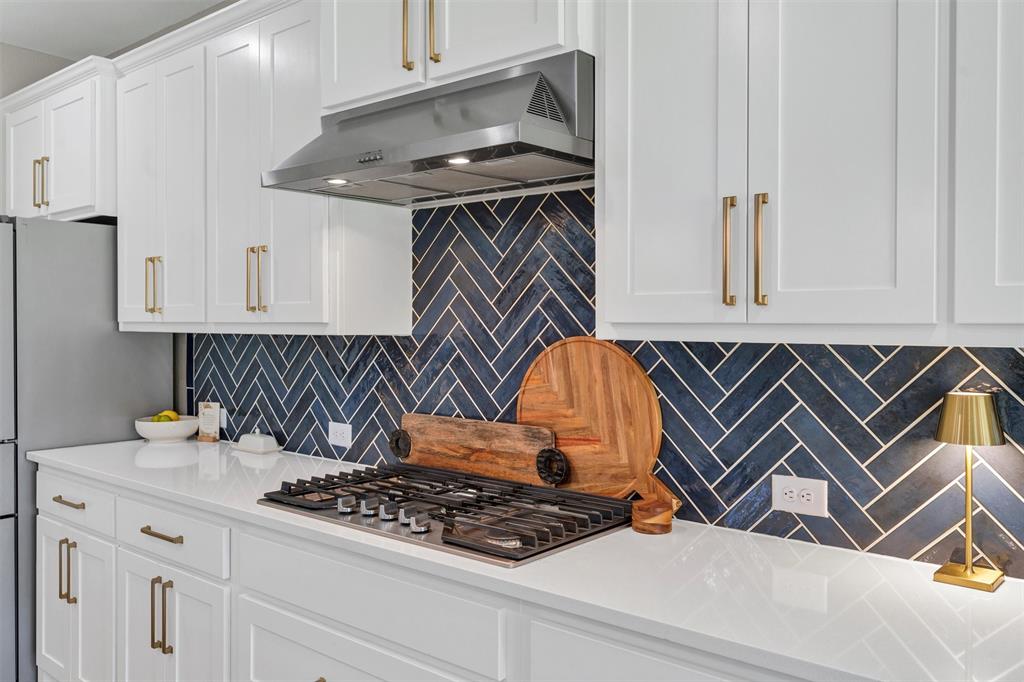 136 Derrett Lane Rhome, TX 76078 - Photo 12 of 40 a kitchen with white cabinets and appliances