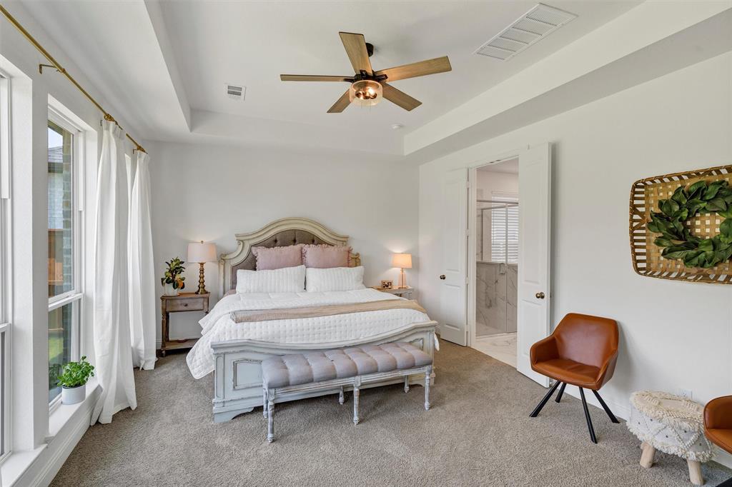 136 Derrett Lane Rhome, TX 76078 - Photo 22 of 40 a bedroom with a bed and a chandelier