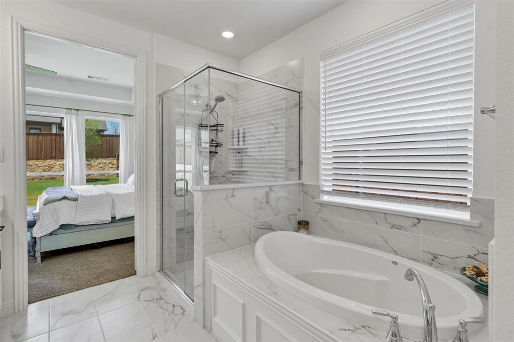 136 Derrett Lane Rhome, TX 76078 - Photo 23 of 40 a bathroom with a tub a sink and a window