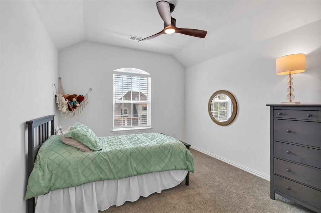 136 Derrett Lane Rhome, TX 76078 - Photo 28 of 40 a bedroom with a bed and a chandelier