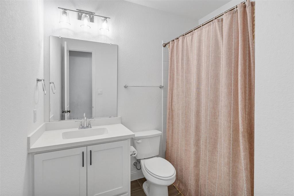 136 Derrett Lane Rhome, TX 76078 - Photo 32 of 40 a bathroom with a sink a toilet and shower