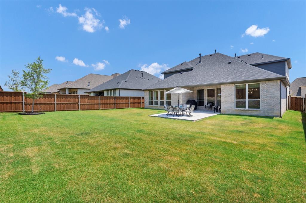 136 Derrett Lane Rhome, TX 76078 - Photo 36 of 40 a front view of a house with a garden and patio