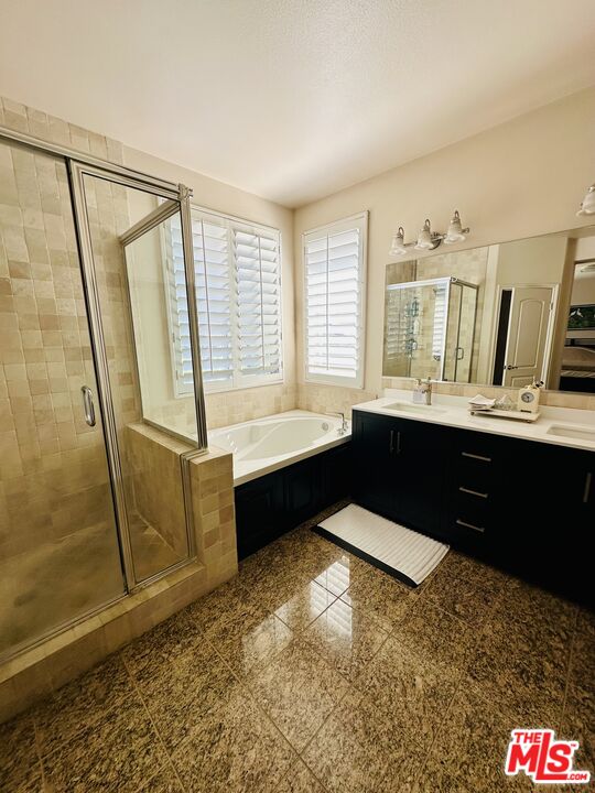 2078 Nohl Ranch Road Orange, CA 92867 - Photo 6 of 13 a spacious bathroom with a tub a sink and a mirror